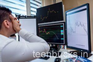 Indian college student stressed looking at falling stock market chart on laptop with options trading losses
